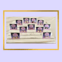 a group of pink and purple stud earrings on a wooden stand