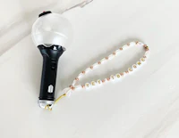 a light bulb with a necklace attached to it